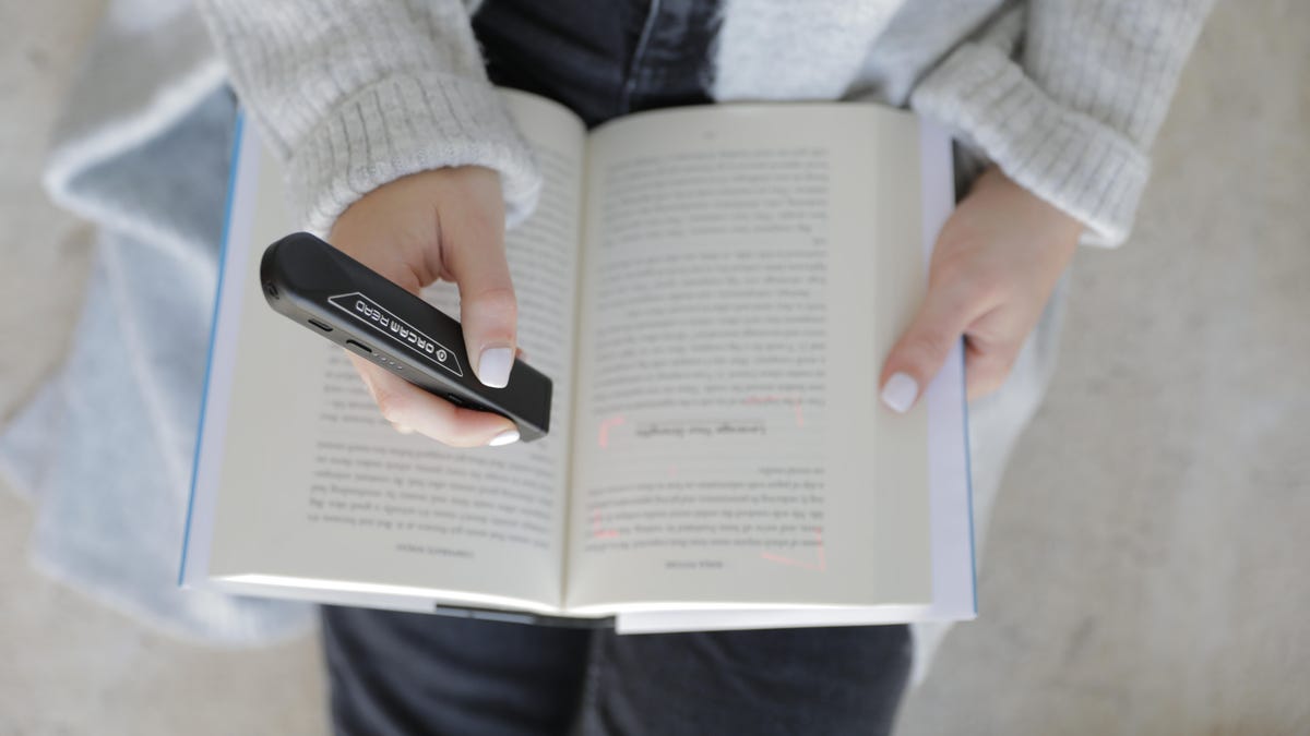 OrCam Read device and open book