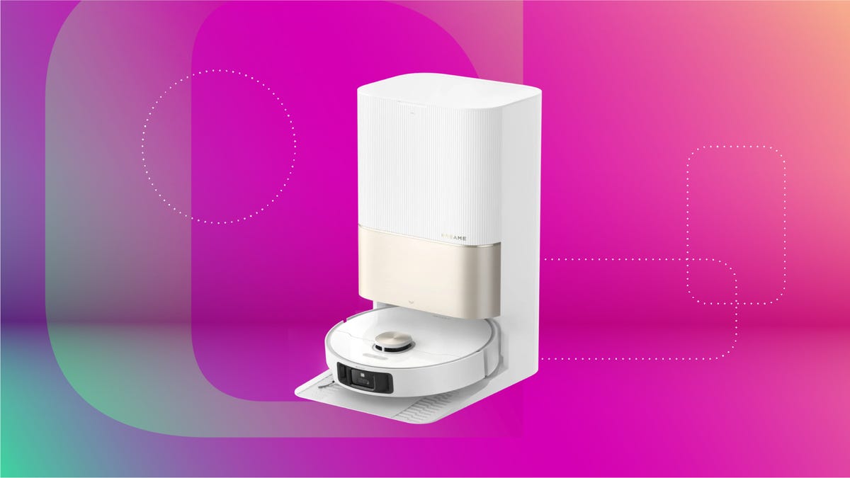 White robot vacuum with dock against magenta CNET background