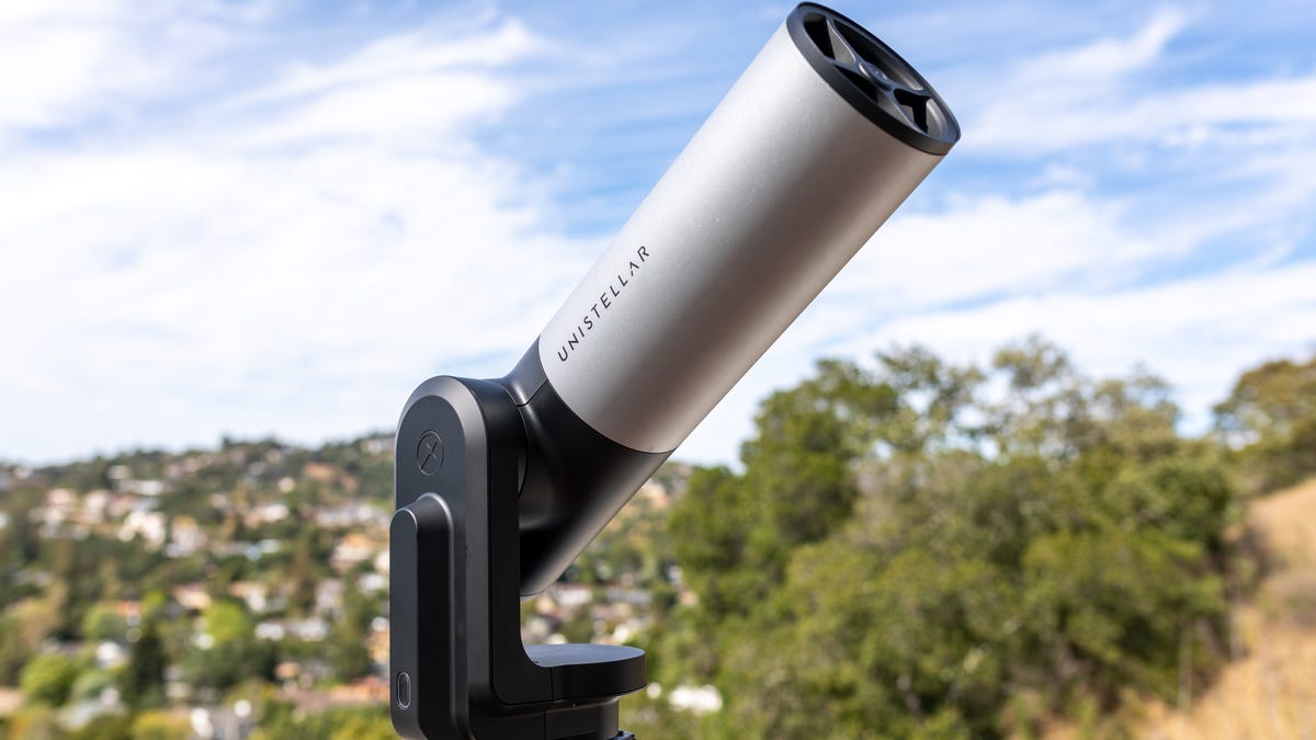The Unistellar EVscope 2 digital telescope mounted on a tripod and pointed upward