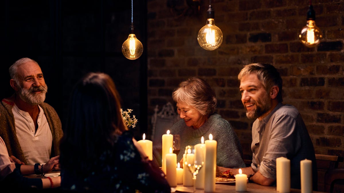 group enjoying candlelit dinner together