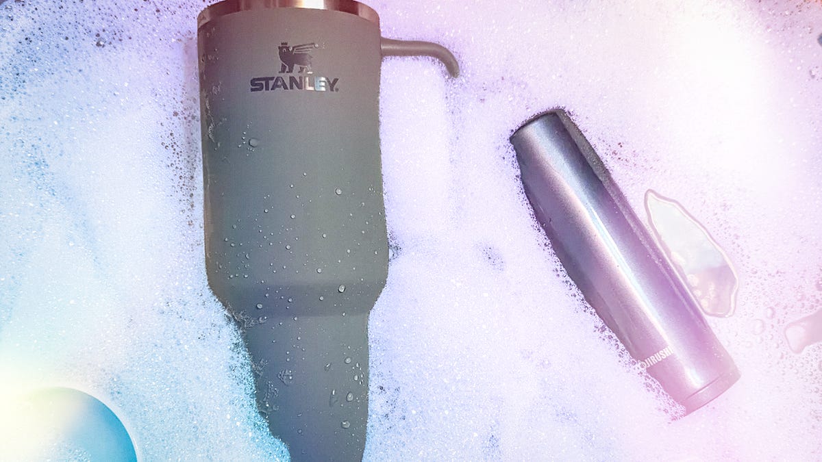 A Stanley cup in soapy water with a purple and blue overlay