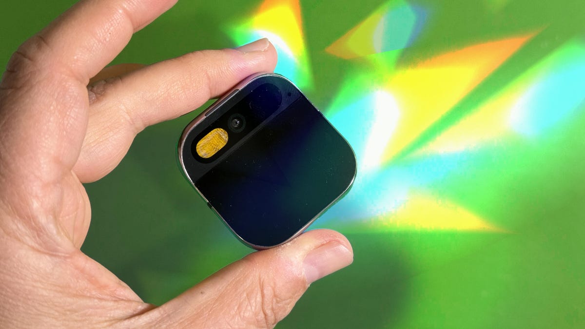 Hand holding the Humane AI Pin