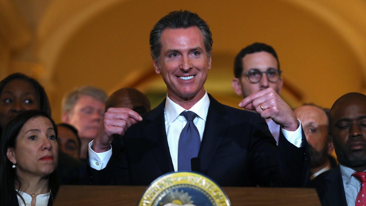 California Gov. Gavin Newsom speaks from behind a podium at a news conference in Sacramento in March.