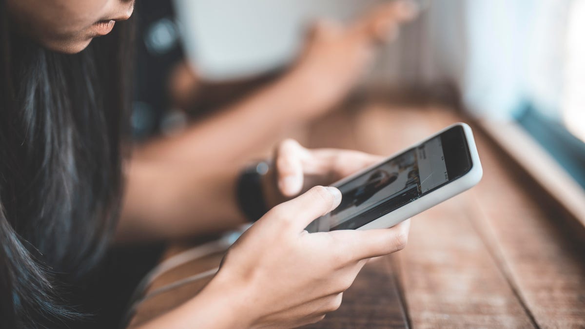 Girl looking at Instagram on phone