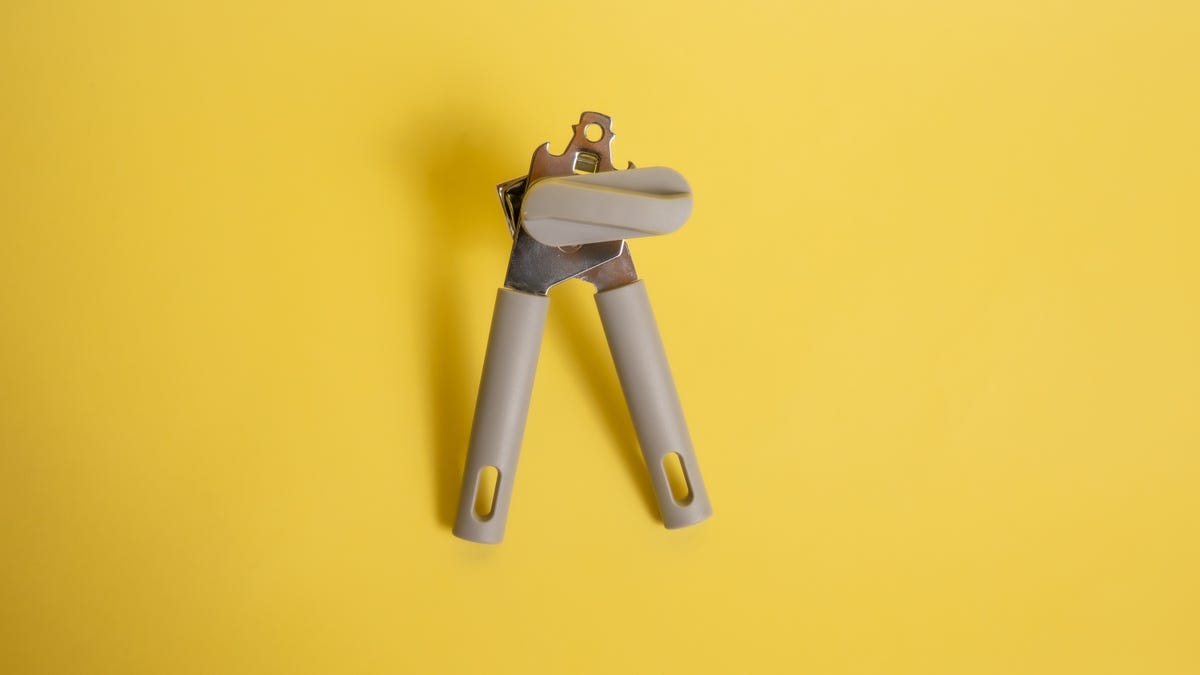 A can opener on a yellow background.
