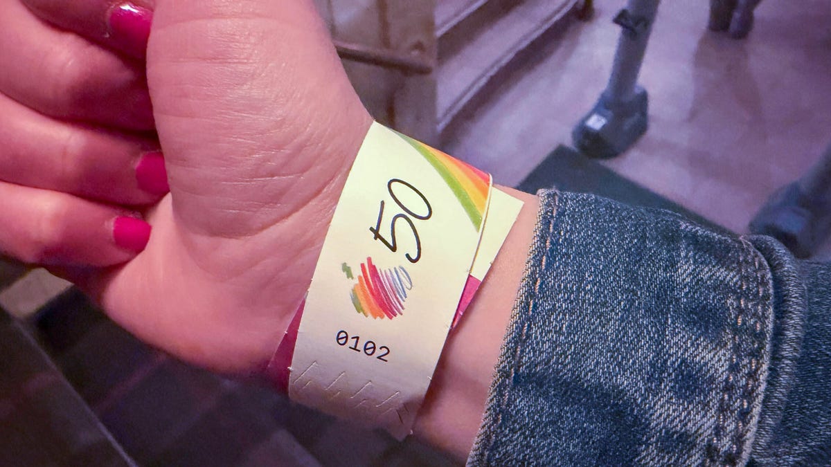 Wristband with a picture of a rainbow Apple logo and 50.