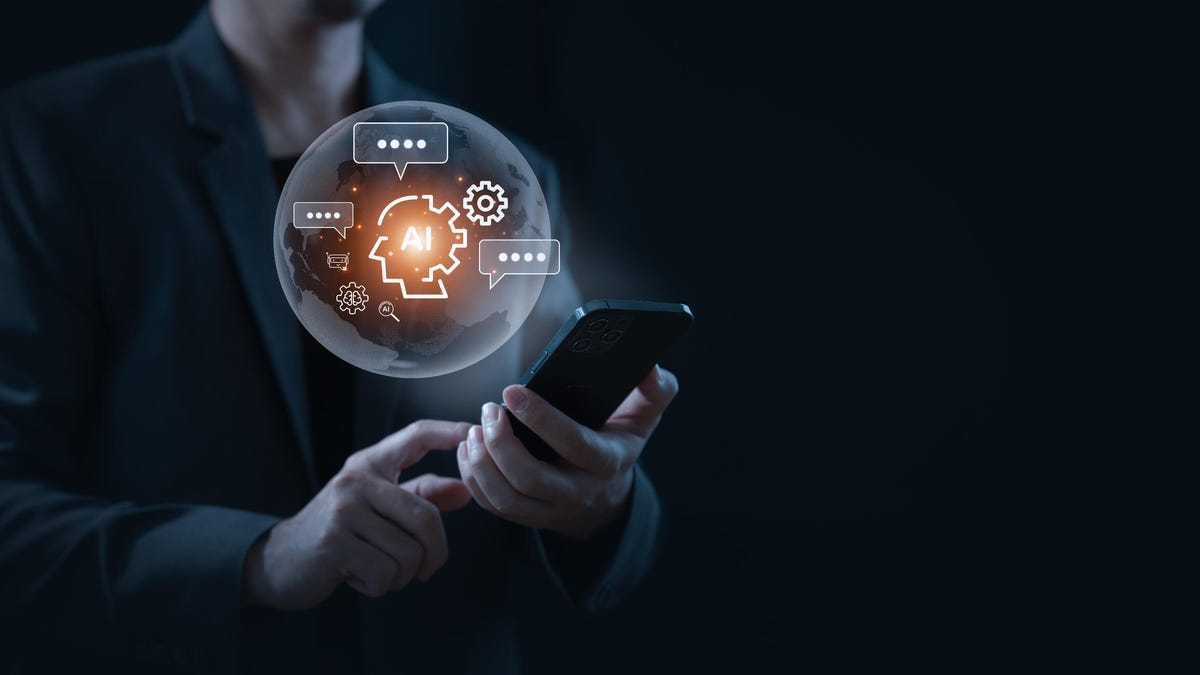 A man in the dark holds a phone with an AI chatbot bubble floating above it.