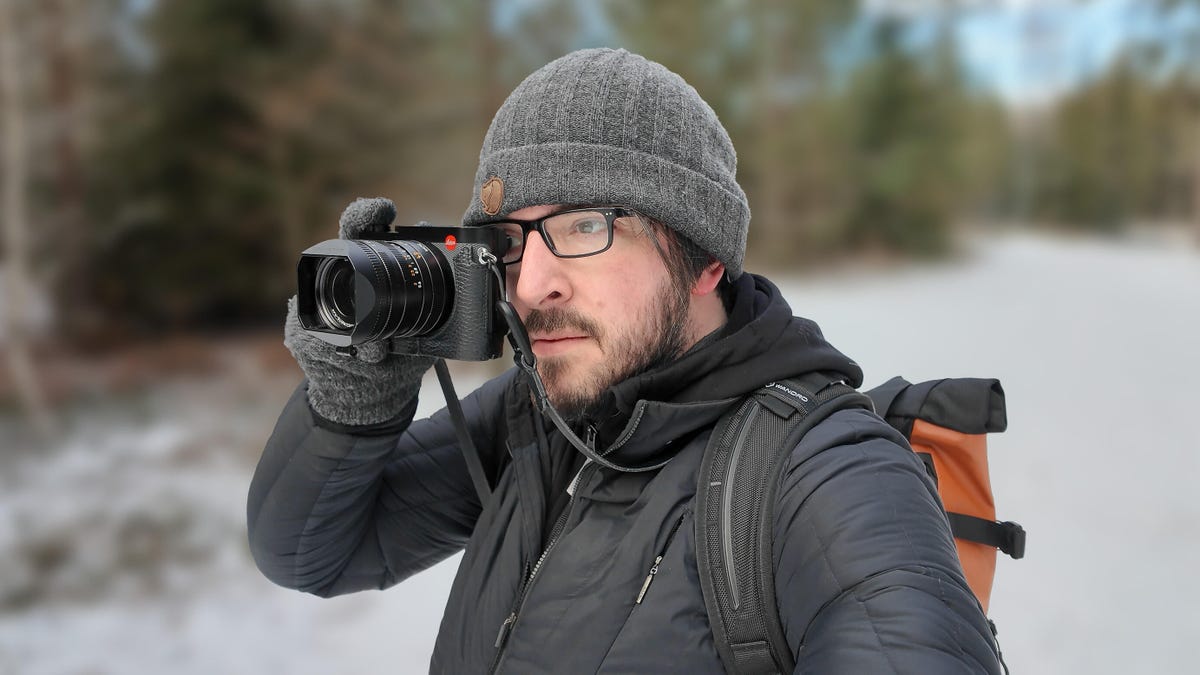 Image of a man holding a camera to his eye.