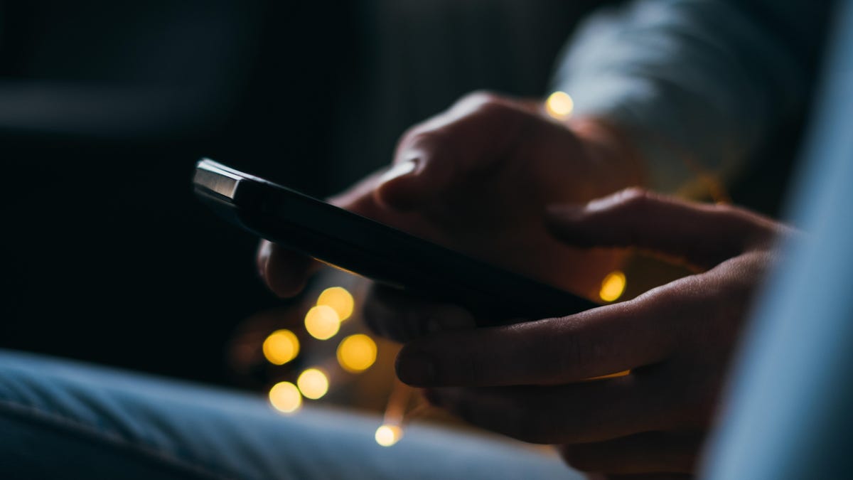 Cropped Image Of Person Using Phone At Night