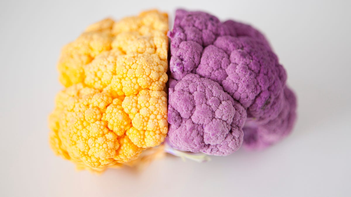 Yellow and purple cauliflower heads put together resembling a brain