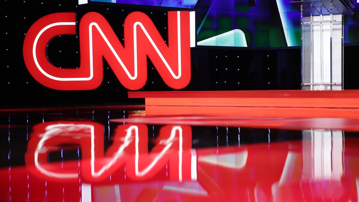 A photo of CNN's red logo on a stage.