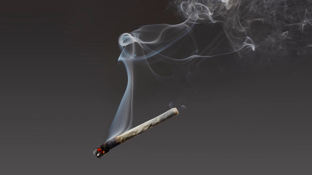 marijuana cigarette suspended in air with smoke wafting