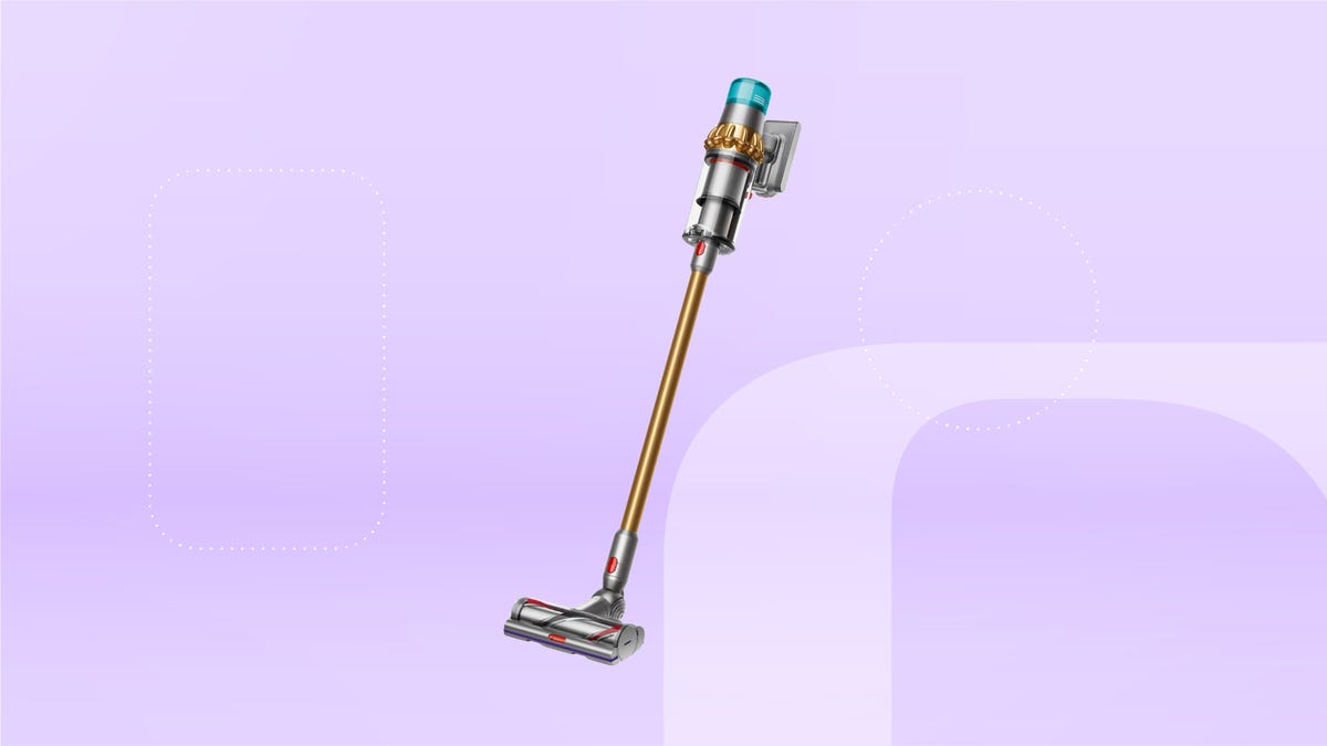 A cordless stick vacuum in copper, with silver and turquoise accents, set against a pastel lavender background.