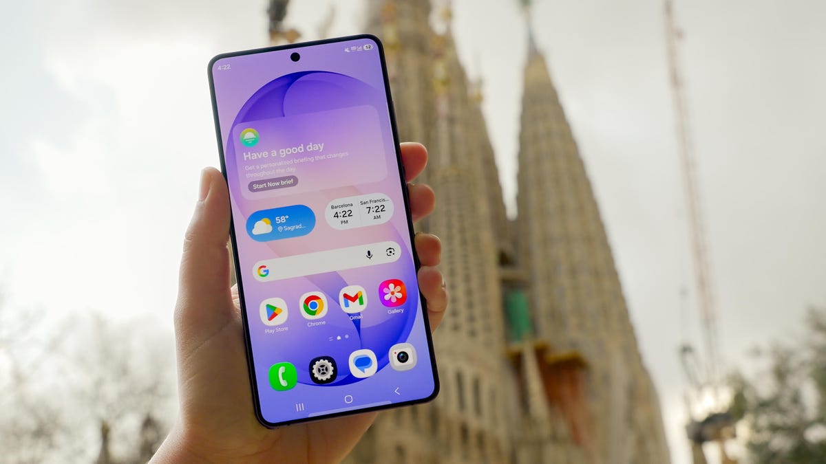 The Samsung Galaxy S26 Ultra is held up in front of the Sagrada Familia