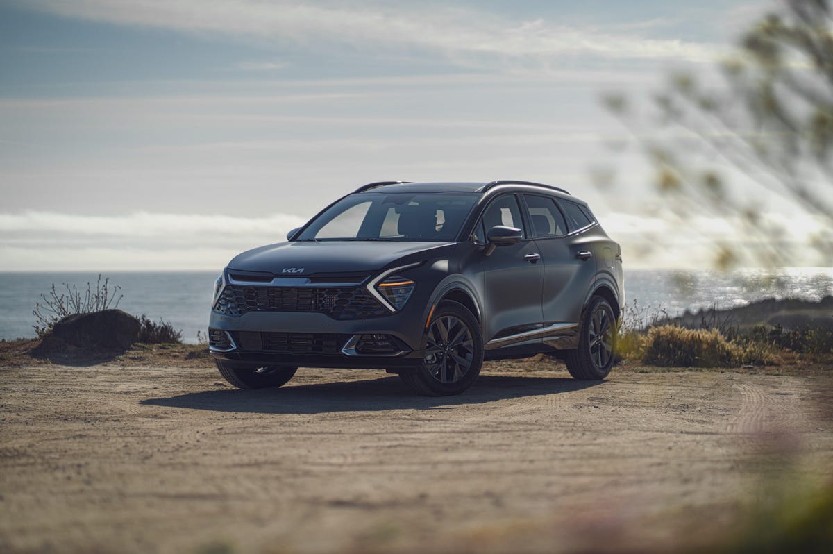 Shadow matte gray 2023 Kia Sportage SX Hybrid at the beach