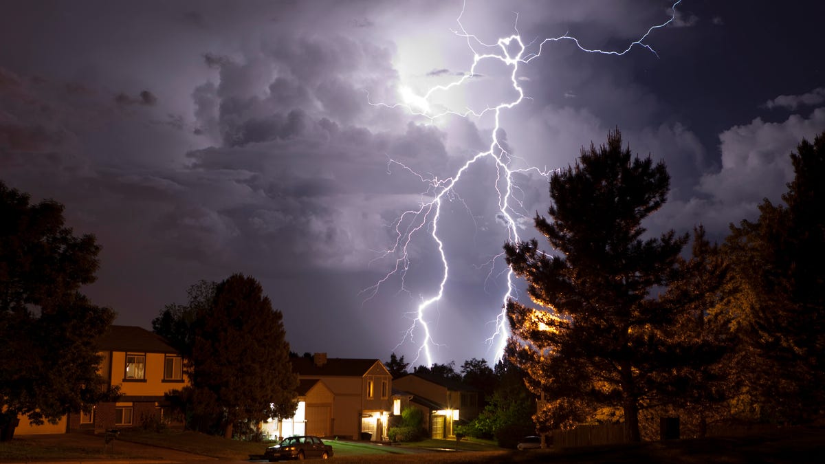 Lightning at night above houses