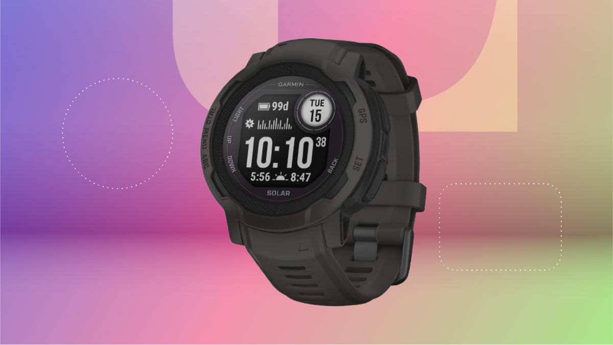 Black smartwatch with round face. Background: purple, pink and green.