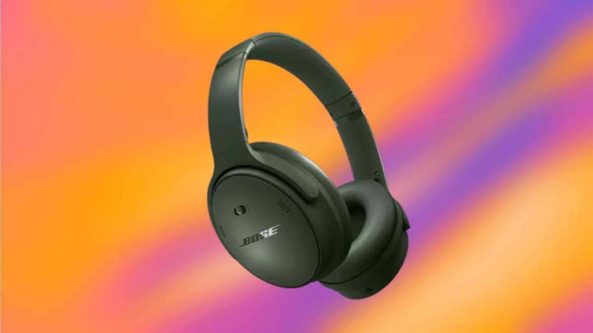 A pair of dark green Bose over-ear headphones set against an orange and purple background