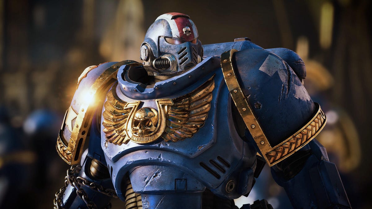 a space marine in his armor looking off to the side