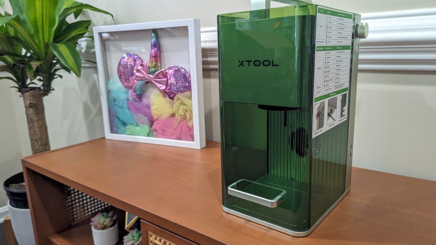 XTool F1 on a table with Disney ears in a frame 