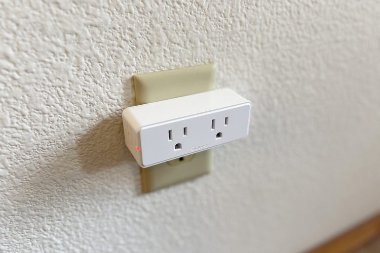 Govee's white dual smart plug on an outlet on a white wall. 