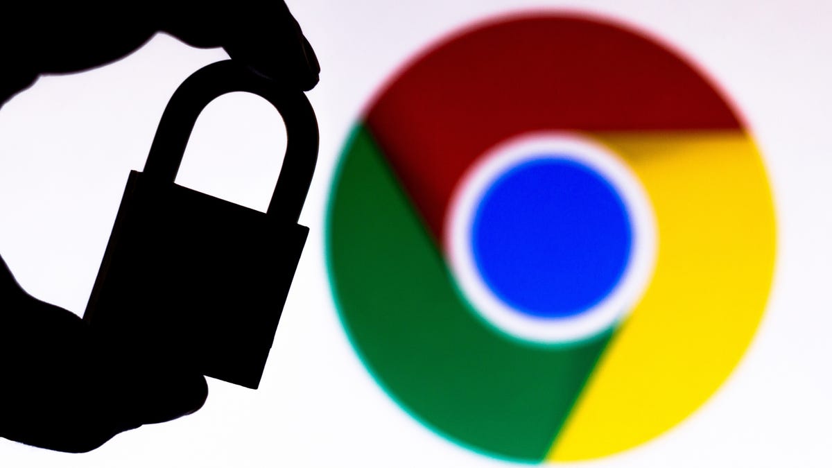 person holds shaded padlock in front of Google Chrome logo