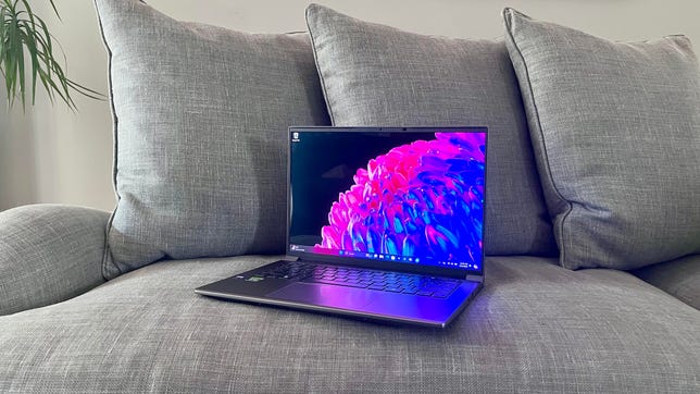 Acer Swift X 14 2024 laptop on a gray couch