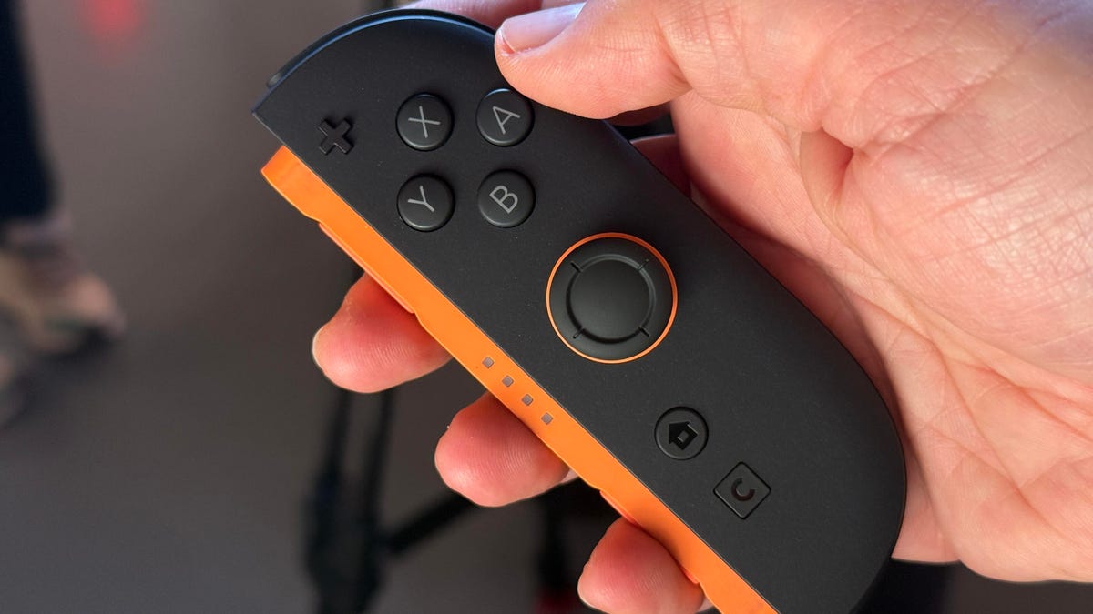 A hand holding the Switch 2 Joy-Con controller