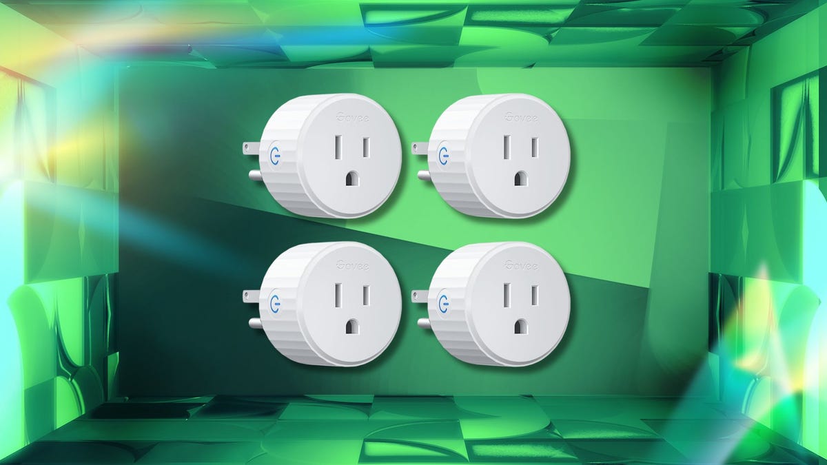 Four white round Govee smart plugs against a CNET background.