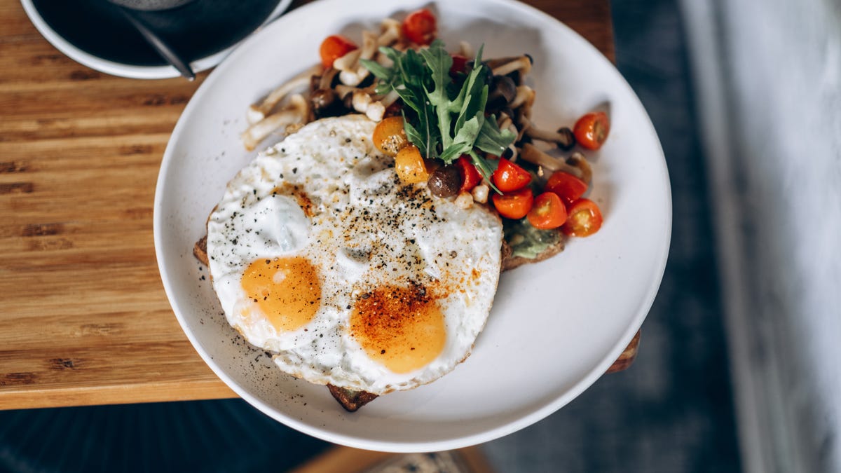 A plate with eggs and vegetables on it.