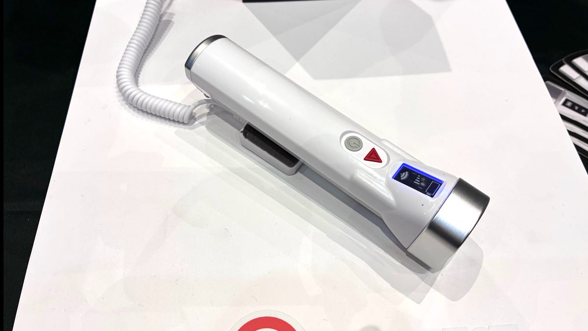 White Timeli emergency flashlight device on white table.