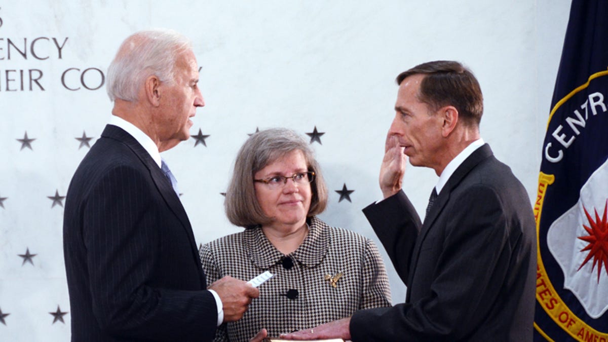 Former CIA director David Petraeus, right, being sworn in by Vice President Joe Biden, left, with his wife at his side, middle.