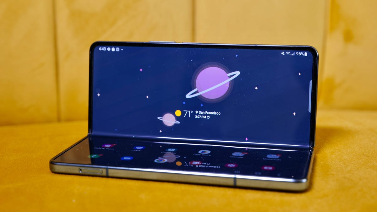 A Galaxy Z Fold 4 on a yellow couch