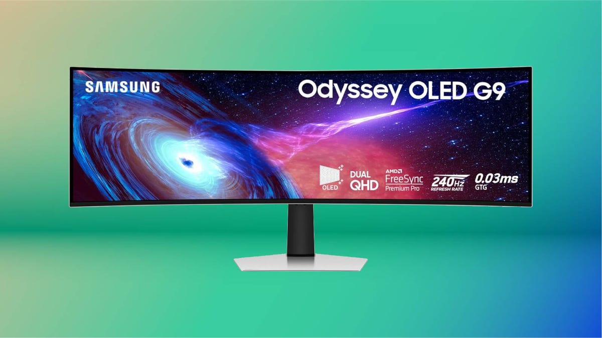 A curved Samsung monitor against a green background.