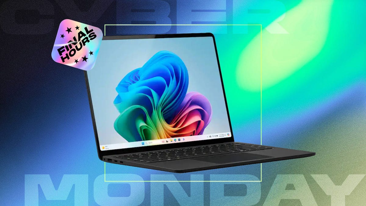 An open Windows laptop against a blue, green and gray CNET background