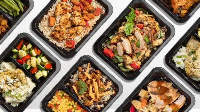 A collection of prepared meals in black containers