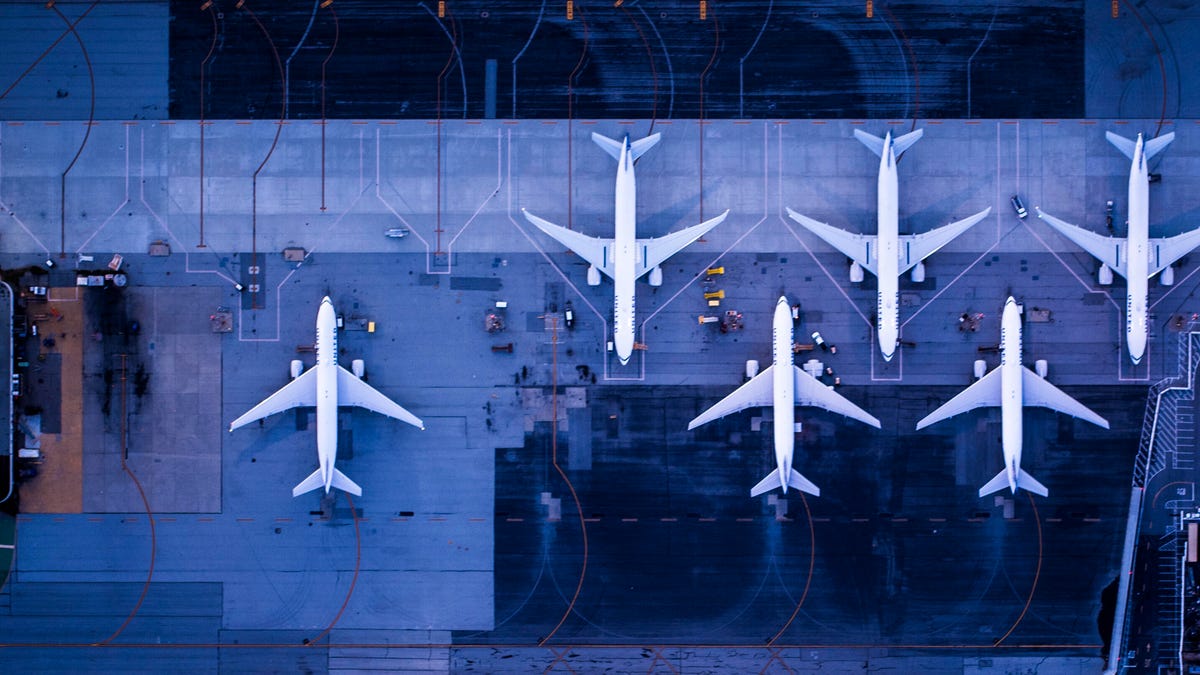 A photo of airplanes parked at an airport, taken from above (gettyimages-970624408)