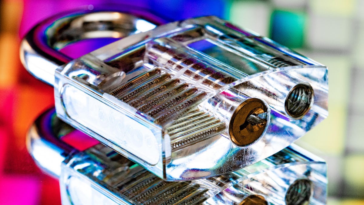 A transparent lock sits on a reflective surface, acting as a metaphor for privacy and security on the internet