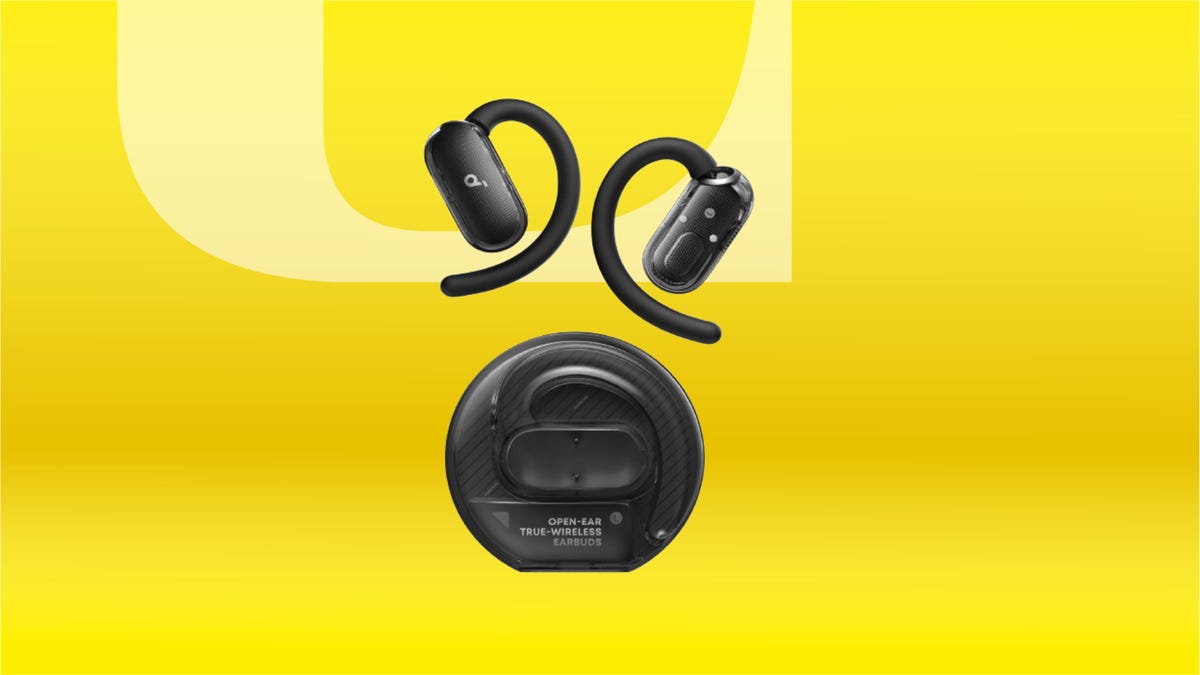 Black over-ear earbuds and charging case. Background: yellow gradient.