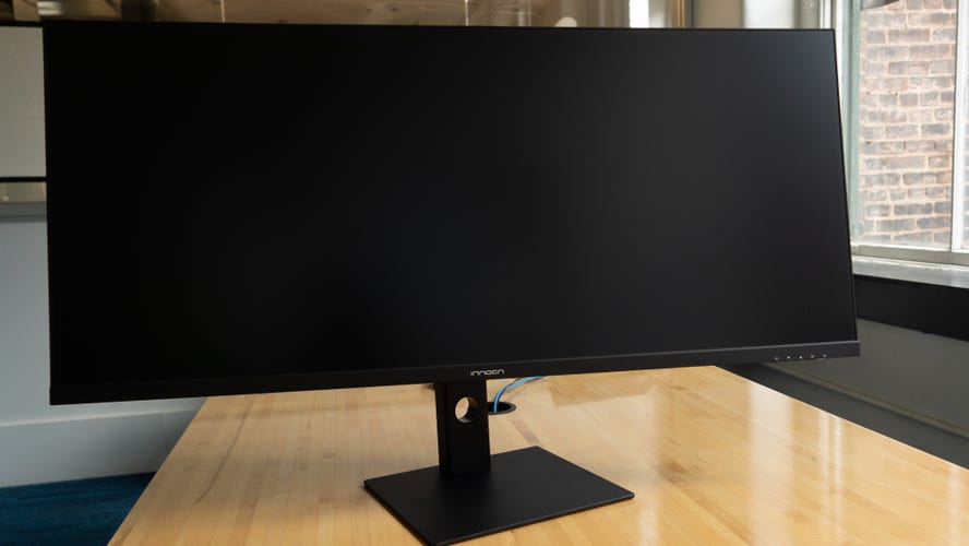 Innocn 40C1R on a conference room table, angled to the right, with a window to a brick wall seen through it.