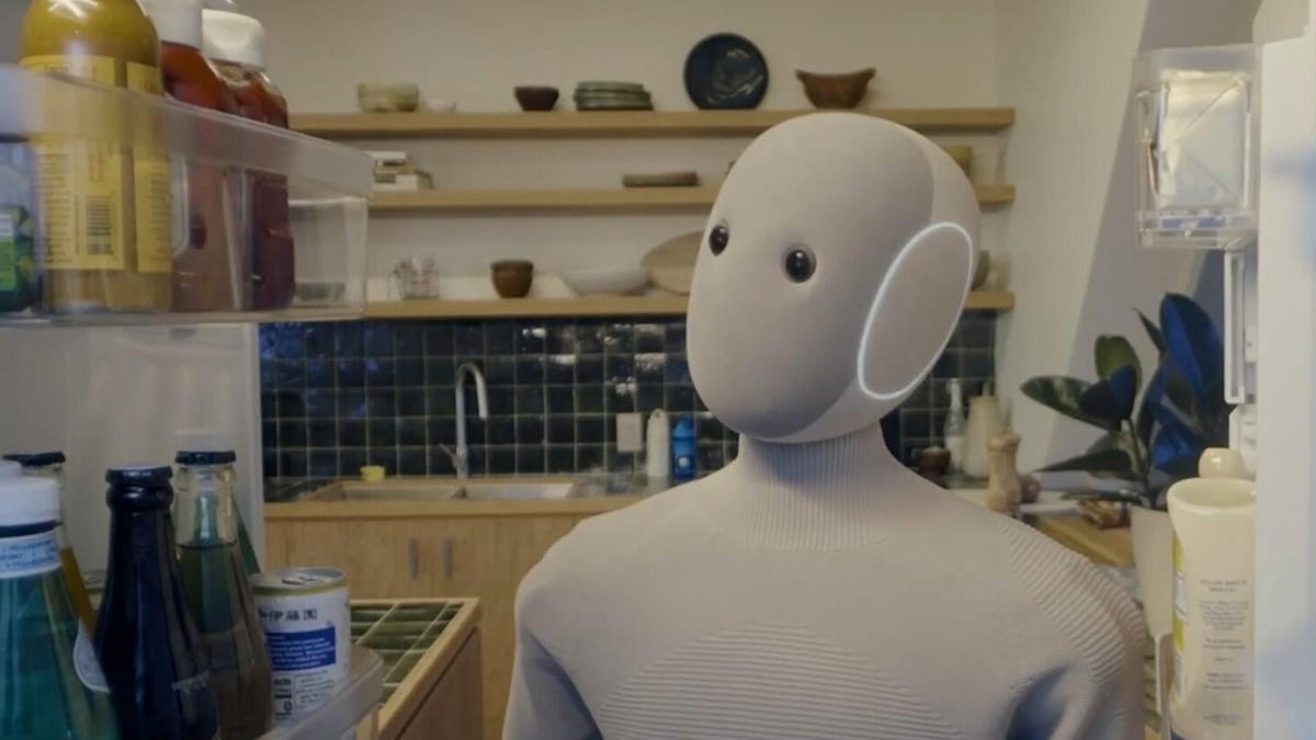 A humanoid robot stands in a kitchen