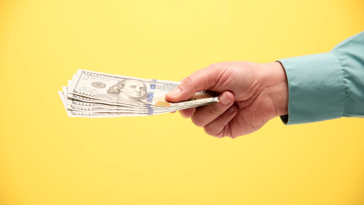 Hand holding 500 US dollars - stock photo