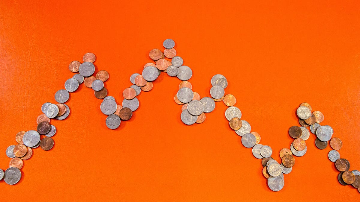 coins in a line like a graph, depicting the stock market tumbling