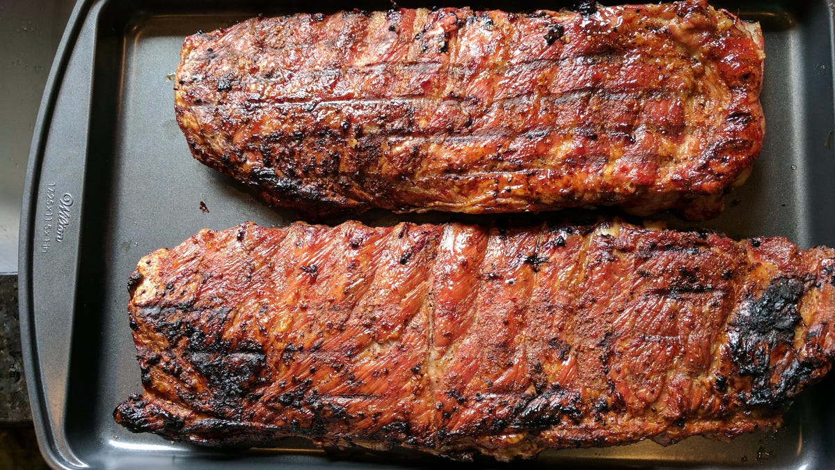 two racks of ribs on baking tray