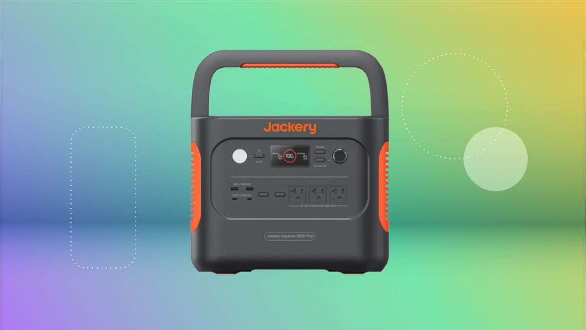 Black Jackery power station with orange accets against purple, blue, green and yellow CNET background.