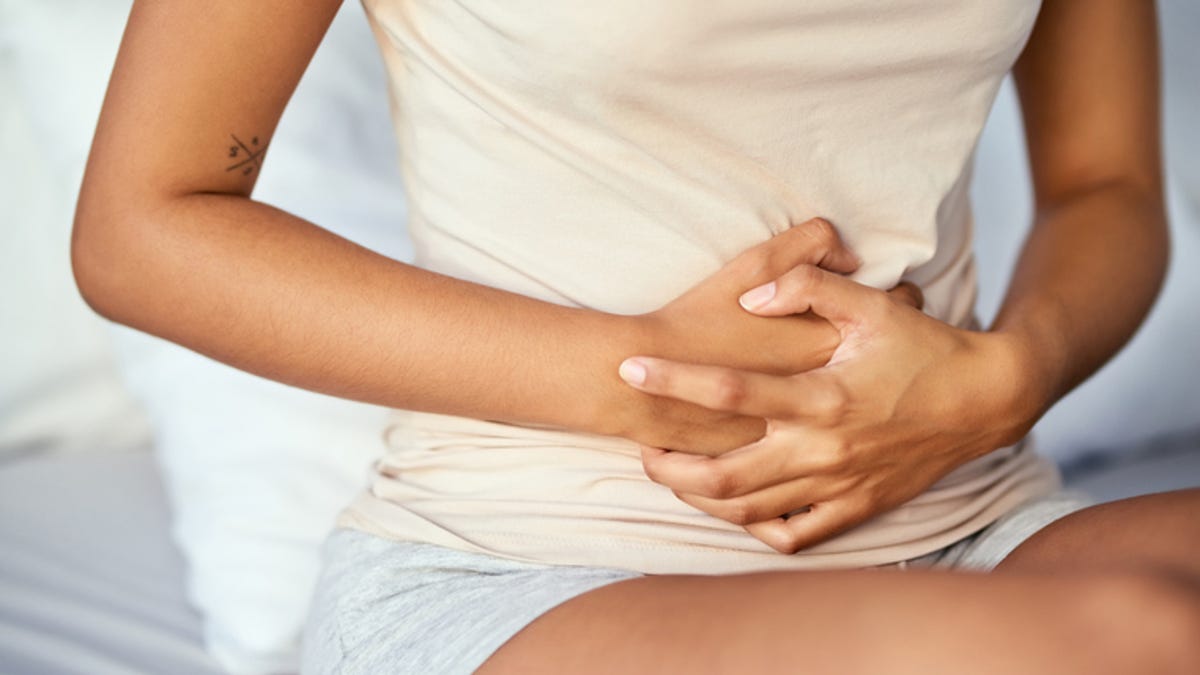 A woman grabbing her stomach in pain
