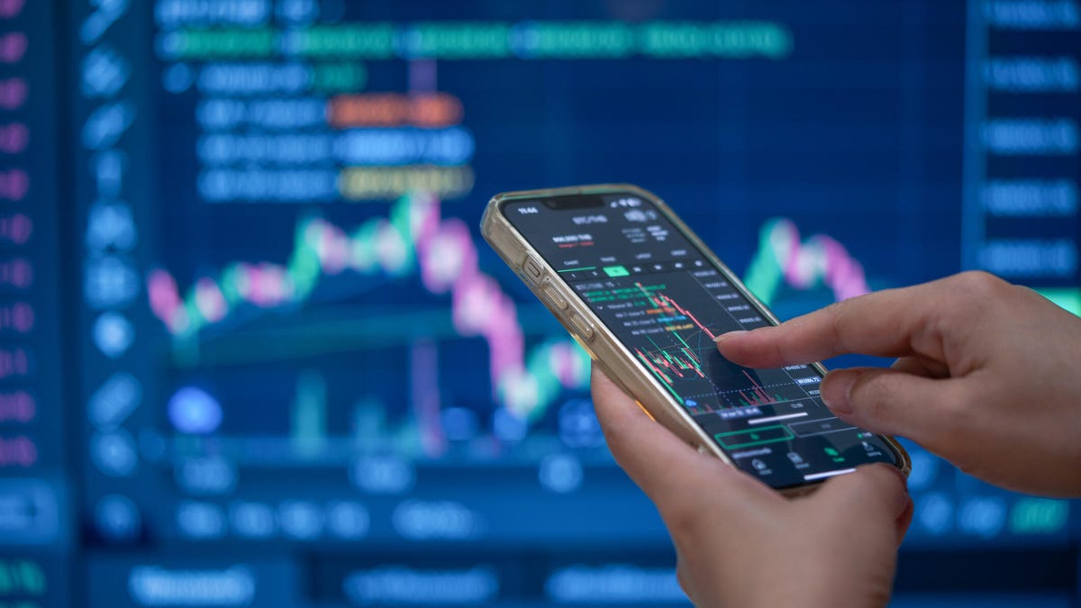 Photo of someone checking stocks on an iPhone