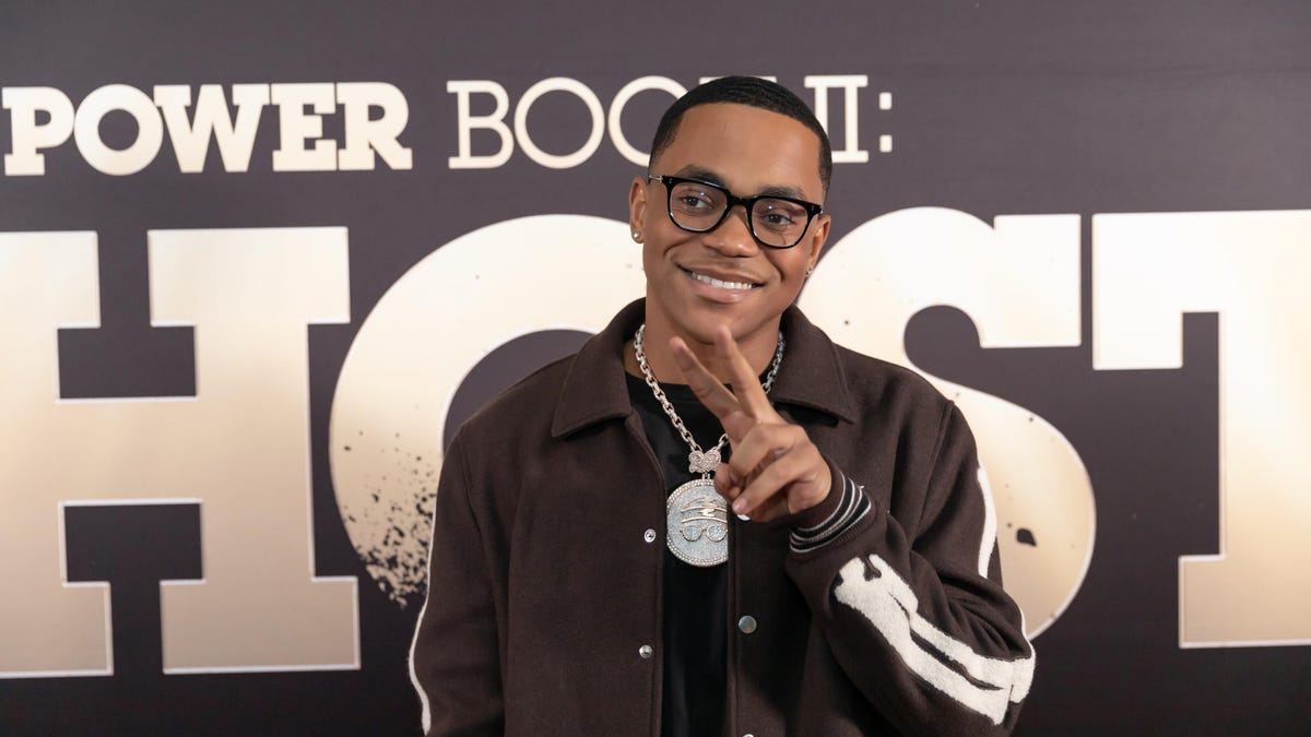 michael rainey jr poses in front of power book 2 backdrop